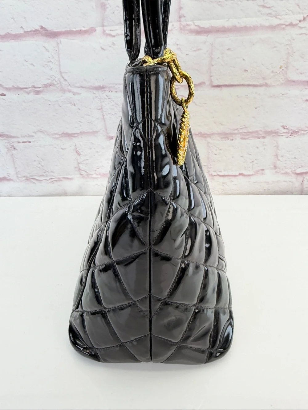 CHANEL Black Quilted Patent Leather Tote with Gold Medallion Charm